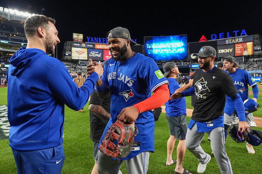 Toronto Blue Jays first baseman Vladimir Guerrero Jr. celebrates with teammates after beating the New York Yankees in Game 4 of baseball's American League Division Series, Wednesday, Oct. 8, 2025, in New York. (AP Photo/Frank Franklin II)