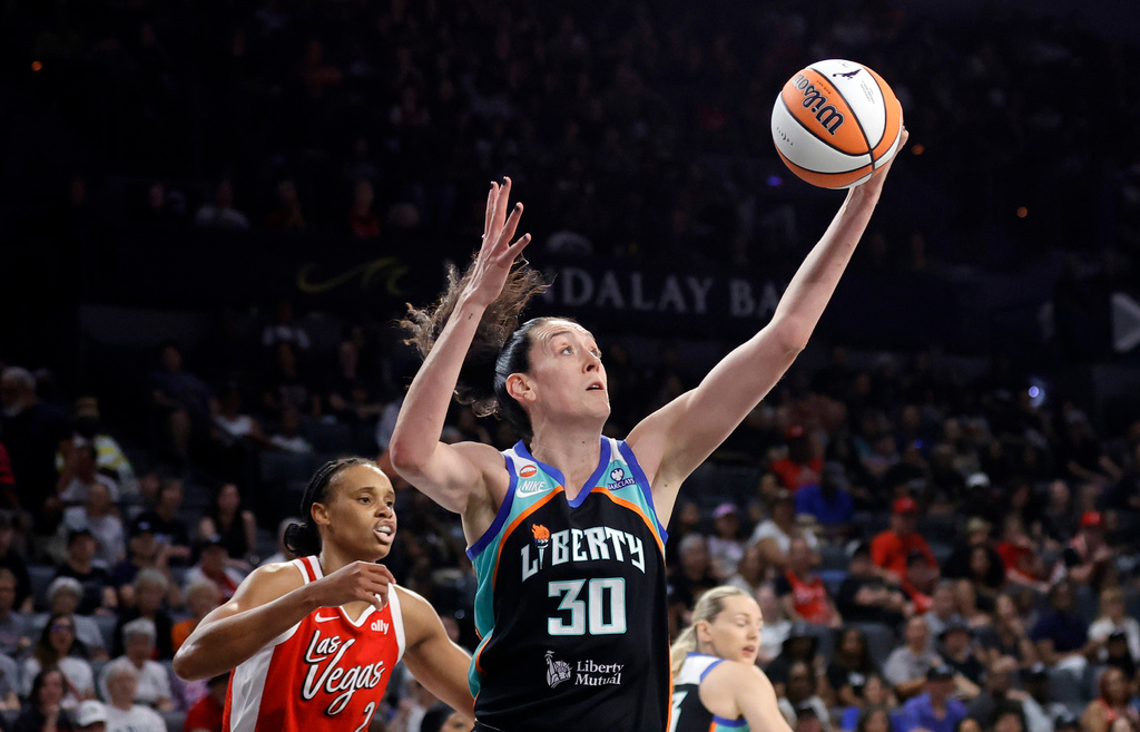 New York Liberty forward Breanna Stewart (30) makes a rebound ahead of Las Vegas Aces forward-center Brianna Turner (21) during the first half of an WNBA basketball game Thursday, July 30, 2026, in Las Vegas. (Steve Marcus/Las Vegas Sun via AP)