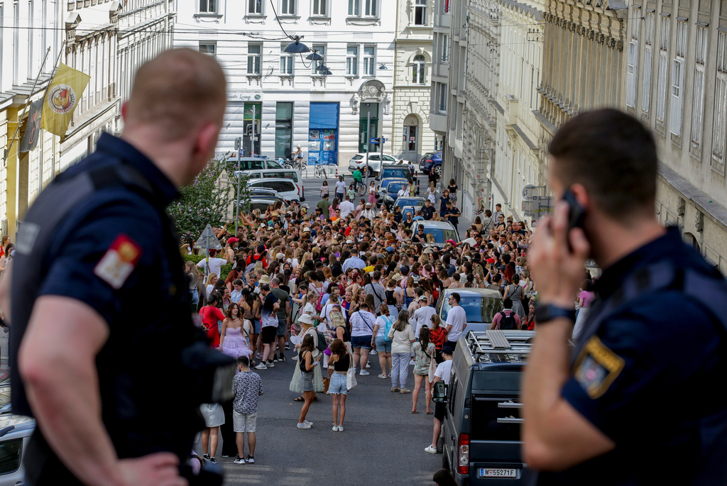 FILE - Austrian police officers watch a gathering of Taylor Swift fans in the city centre in Vienna on Aug. 8, 2024. (AP Photo/Heinz-Peter Bader, File)