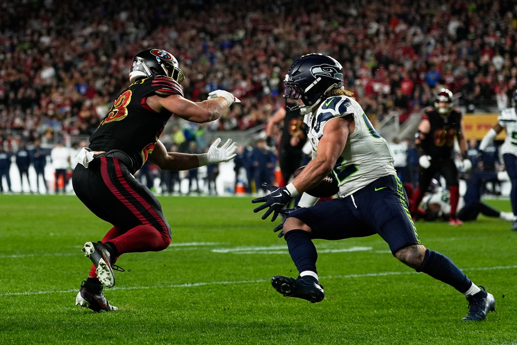 Seattle Seahawks linebacker Drake Thomas, right, intercepts a pass intended for San Francisco 49ers running back Christian McCaffrey, left, during the second half of an NFL football game in Santa Clara, Calif., Saturday, Jan. 3, 2026. (AP Photo/Godofredo A. Vásquez)