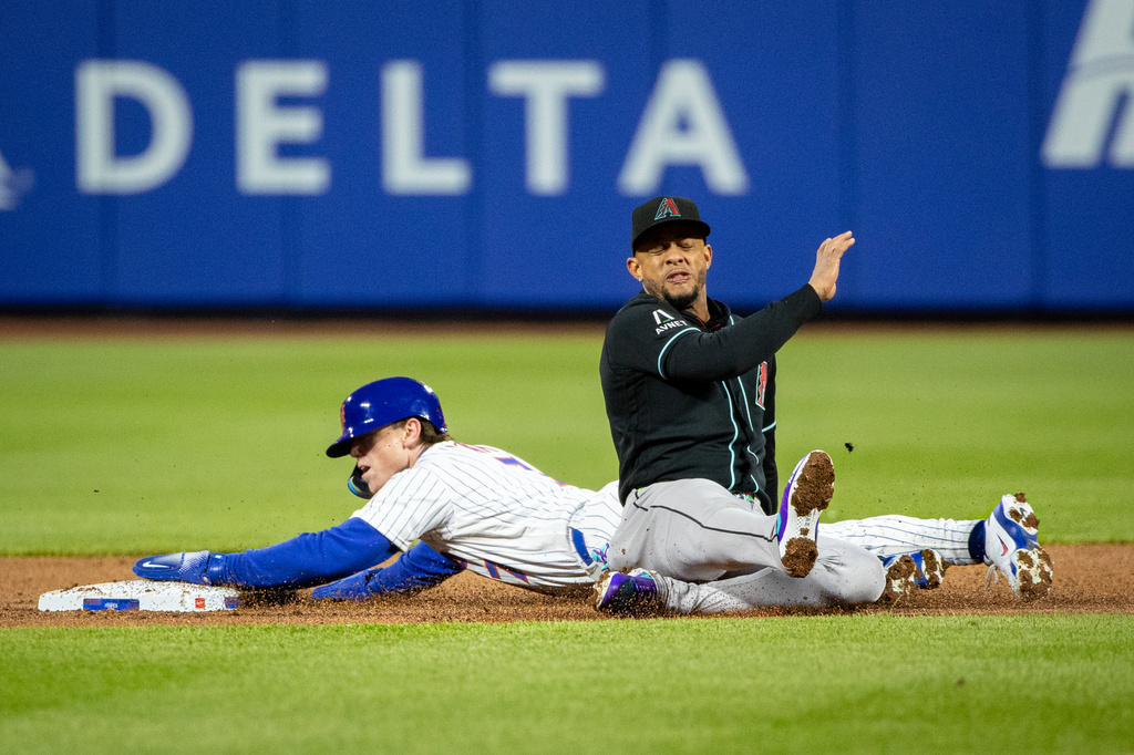 New York Mets' Brett Baty (7) crashes into Arizona Diamondbacks second baseman Ketel Marte (4) as he steals second base during the second inning of a baseball game, Thursday, April 9, 2026, in New York. (AP Photo/Angelina Katsanis)