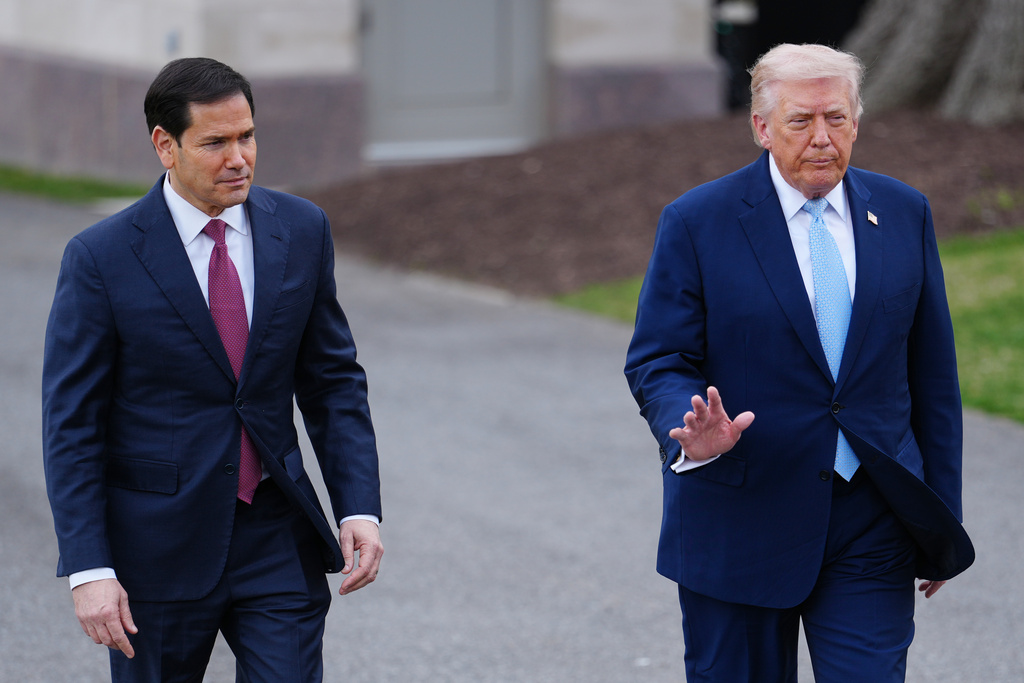 President Donald Trump walks with Secretary of State Marco Rubio to speak with reporters before departing on Marine One from the South Lawn of the White House, Friday, March 20, 2026, in Washington. (AP Photo/Julia Demaree Nikhinson)