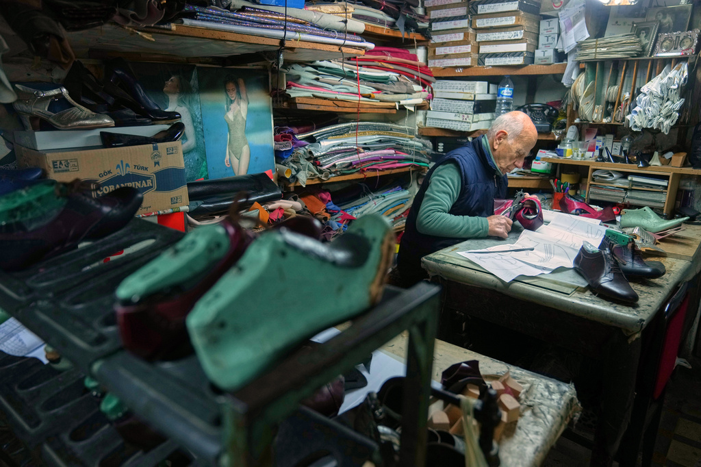 Dance shoe craftsman Ercan Umay works at his workshop in Istanbul, Turkey, Tuesday, Jan. 20, 2026. (AP Photo/Francisco Seco)