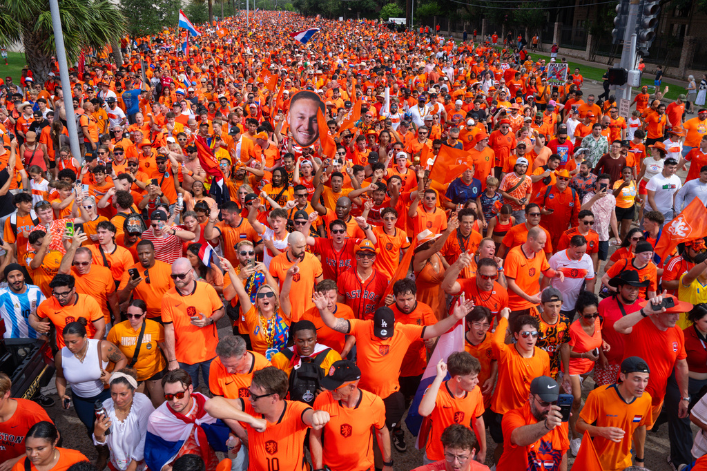 Netherlands fans take part in an "Orange Walk" to Houston Stadium before a FIFA World Cup Group F soccer match between Netherlands and Sweden in Houston, Saturday, June 20, 2026. (AP Photo/Jon Shapley)