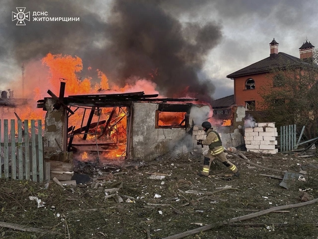 In this photo provided by the Ukrainian Emergency Services on Wednesday, Sept. 10, 2025, a rescue worker puts out a fire in a house destroyed by a Russian strike on a residential neighbourhood in Zhytomyr region, Ukraine. (Ukrainian Emergency Service via AP)