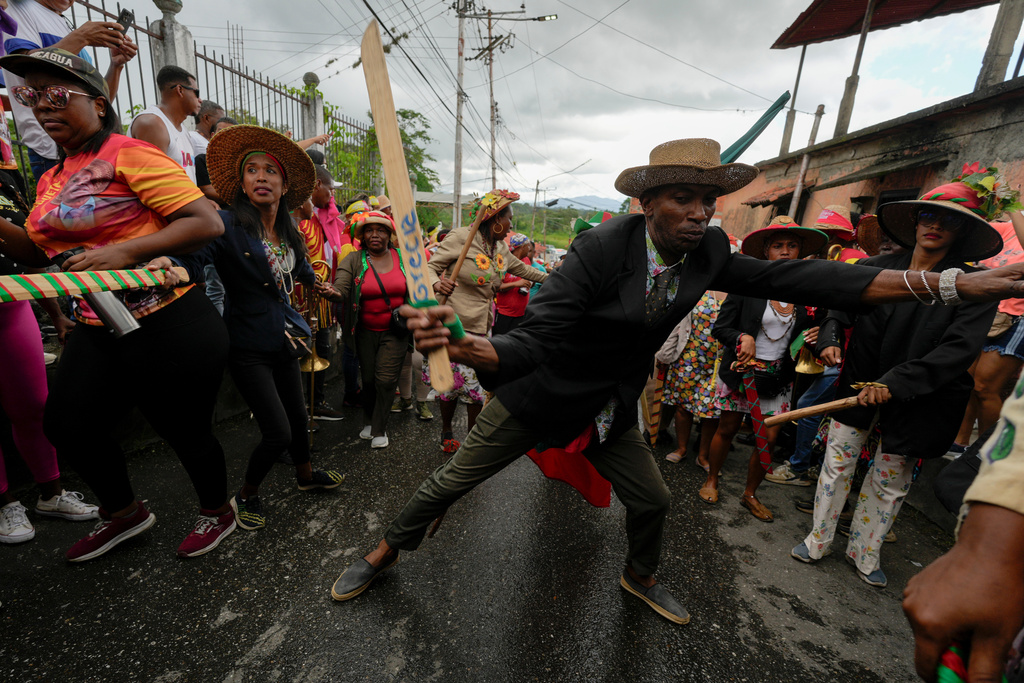 Revelers take part in the Afro-Venezuelan Holy Innocents' Day celebration in Caucagua, Venezuela, Sunday, Dec. 28, 2025. (AP Photo/Matias Delacroix)
