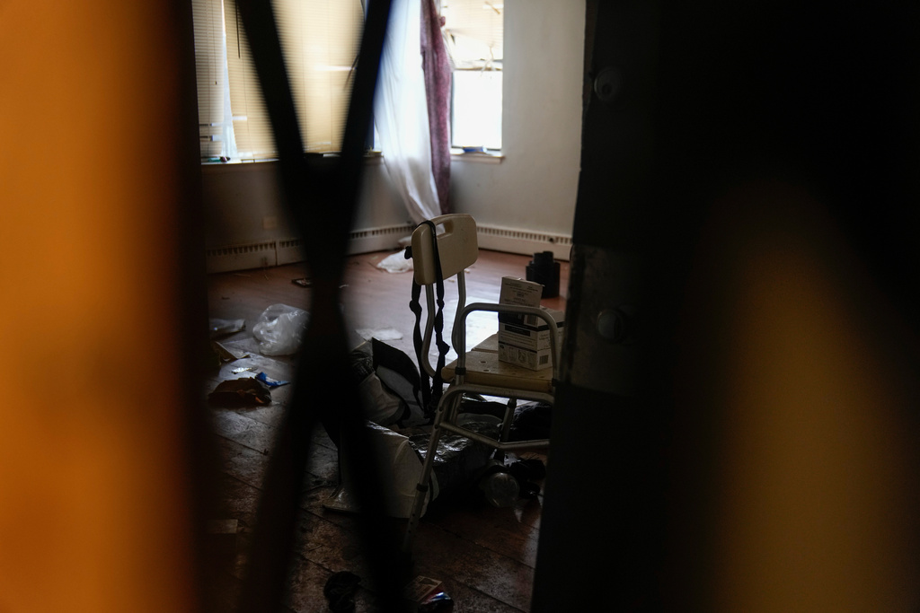 Items are seen on Oct. 10, 2025, in a boarded-up apartment with broken windows inside the building at 7500 South Shore Drive in Chicago, which was raided by federal agents on Sept. 30. (AP Photo/Erin Hooley)