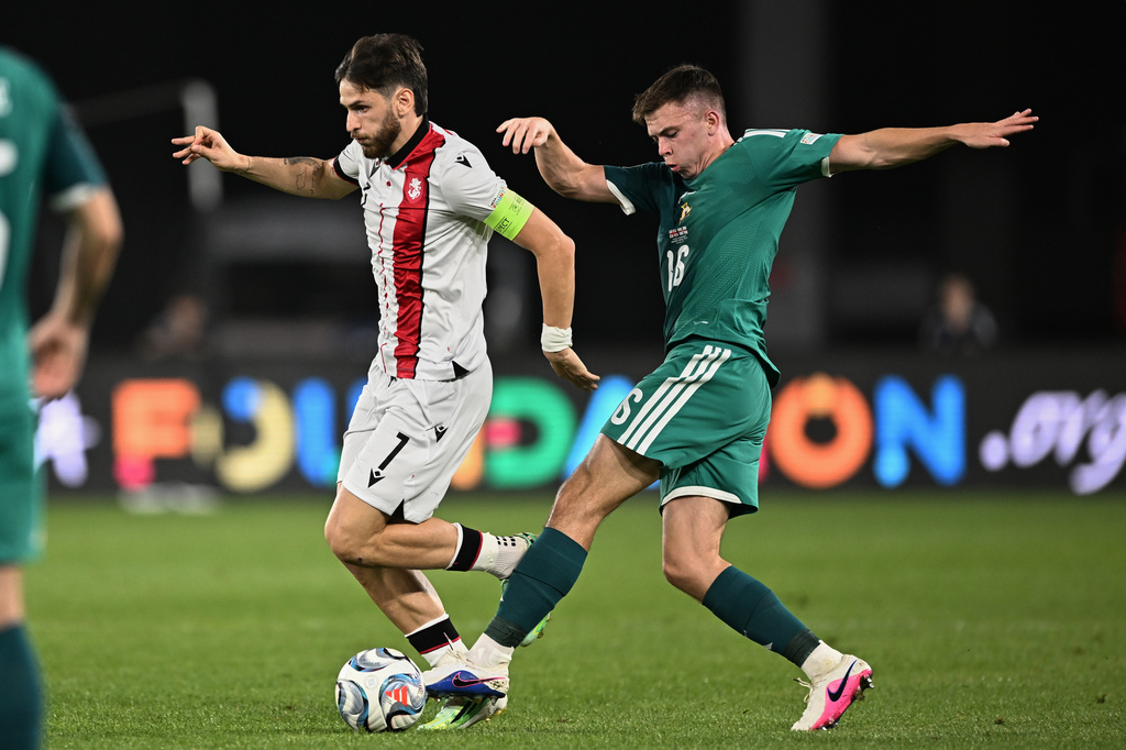 Georgia's Khvicha Kvaratskhelia, left, and Northern Ireland's Patrick Kelly challenge for the ball during the Nations League soccer match between Georgia and Northern Ireland in Tbilisi, Georgia, Friday, Sept. 25, 2026. (AP Photo/Tamuna Kulumbegashvili)