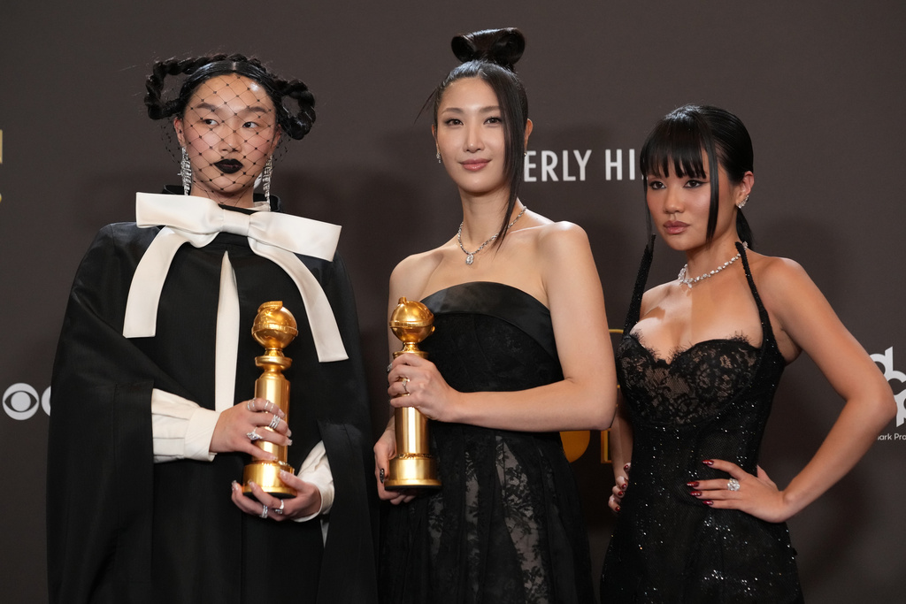 Audrey Nuna, from left, EJAE, and Rei Ami pose in the press room with the award for best original song – motion picture for "Golden" from "Kpop Demon Hunters" during the 83rd Golden Globes on Sunday, Jan. 11, 2026, at the Beverly Hilton in Beverly Hills, Calif. (AP Photo/Chris Pizzello)