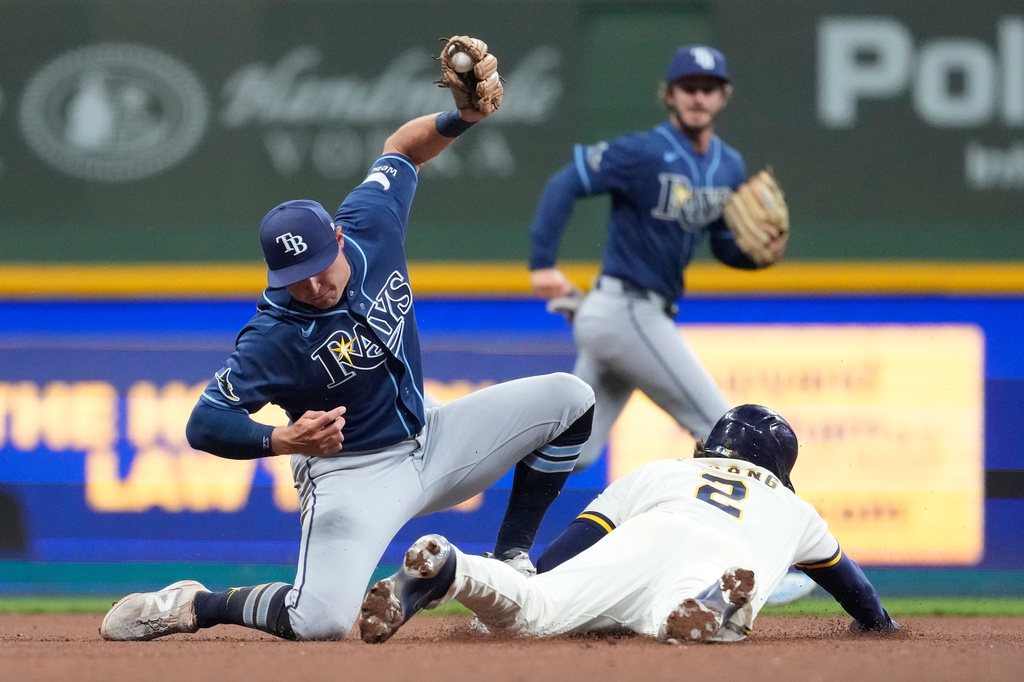 Milwaukee Brewers' Brice Turang (2) steals second base past Tampa Bay Rays' Ben Williamson during the eighth inning of a baseball game Monday, March 30, 2026, in Milwaukee. (AP Photo/Aaron Gash)