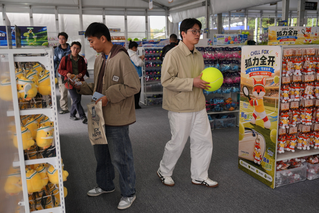 People shop for plush toys at a souvenir store during the China Open tennis championships in Beijing, Wednesday, Sept. 30, 2026. (AP Photo/Andy Wong)