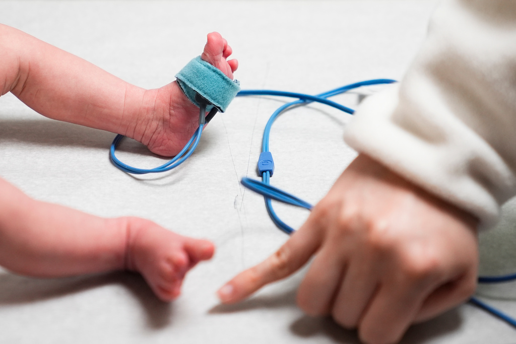 FILE - A medical assistant takes the pulse of a one month-old patient during a checkup at the Seattle Indian Health Board Clinic, which relies on federal funding to operate, Thursday, Jan. 30, 2025, in Seattle. (AP Photo/Lindsey Wasson, File)