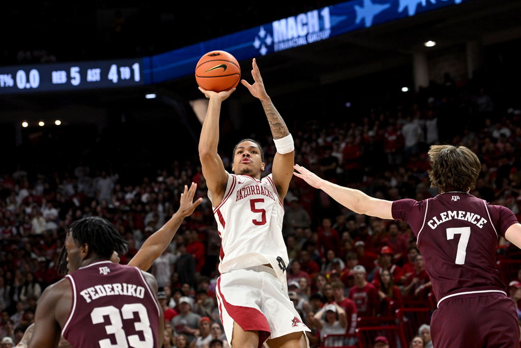 Arkansas guard Darius Acuff Jr. (5) shoots over Texas A&M forward Zach Clemence (7) during an NCAA college basketball game, Wednesday, Feb. 25, 2026, in Fayetteville, Ark. (AP Photo/Michael Woods)