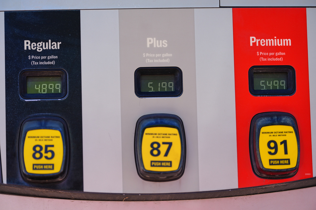 Per-gallon prices are displayed electronically above the various grades of fuel available at a Conoco gasoline station Sunday, Aug. 16, 2026, in southeast Denver. (AP Photo/David Zalubowski)