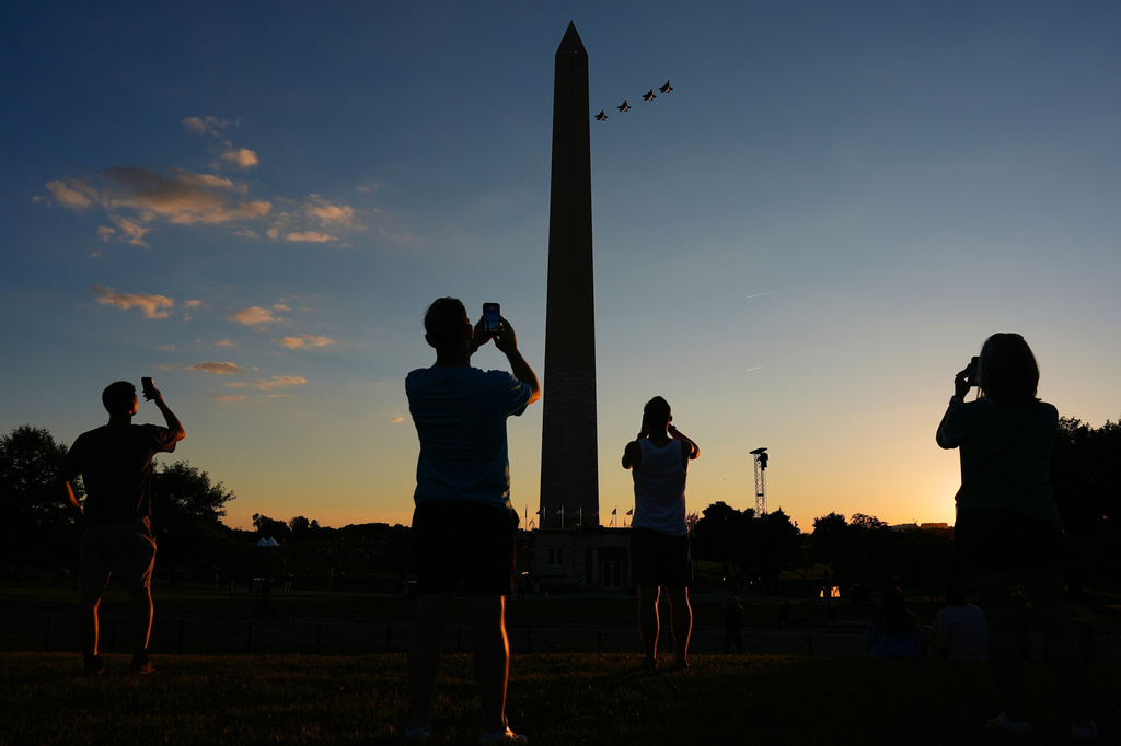 People record the F-35 formation flyover as it approaches the Washington Monument during the opening of the Great American State Fair on the National Mall, Wednesday, June 24, 2026, in Washington. (AP Photo/Carolyn Kaster)