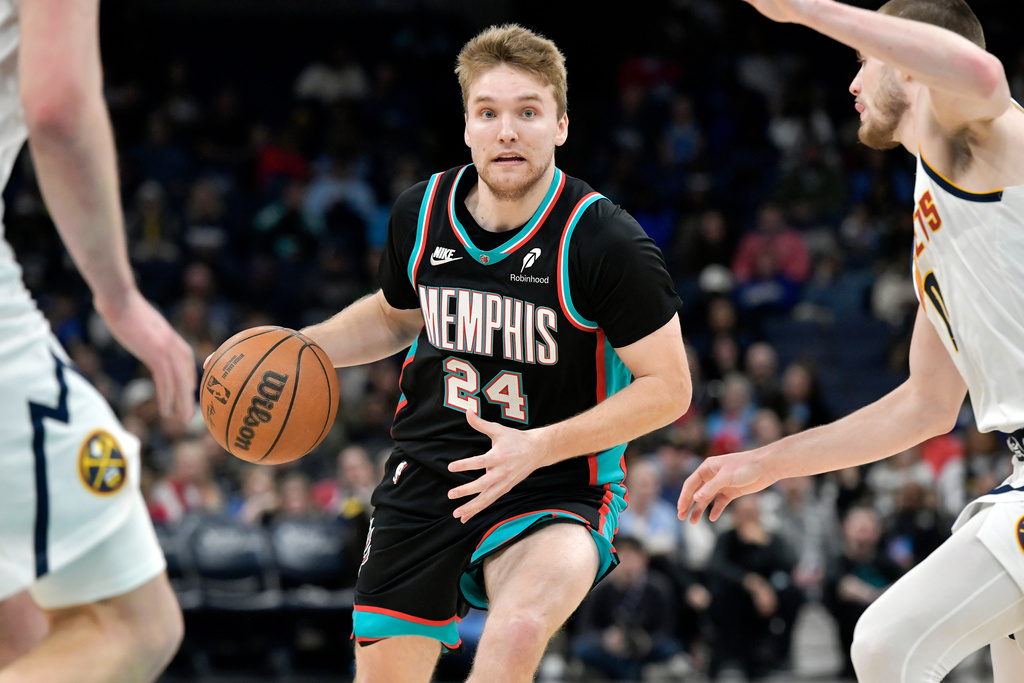 Memphis Grizzlies guard Cam Spencer (24) handles the ball against the Denver Nuggets in the second half of an NBA basketball game Wednesday, March 18, 2026, in Memphis, Tenn. (AP Photo/Brandon Dill)