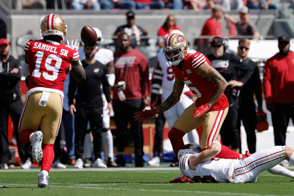 San Francisco 49ers wide receiver Deebo Samuel Sr. (19) catches a lateral from wide receiver Mike Evans (5) before running for a touchdown on the play during the first half of an NFL football game against the Arizona Cardinals in Santa Clara, Calif., Sunday, Sept. 27, 2026. (AP Photo/Kelley L. Cox)
