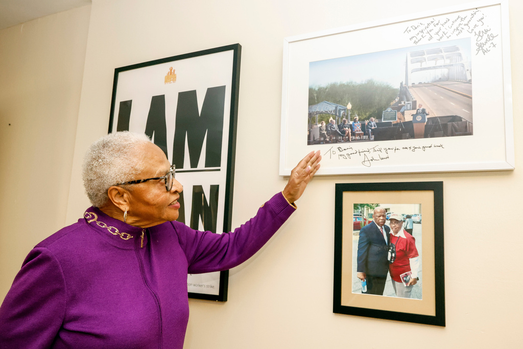 Dorris Crenshaw points to a photo of the Edmund Pettus Bridge as she prepares for the 70th anniversary of Rosa Park's Bus Boycott, Monday, Nov. 24, 2025, in Montgomery, Ala. (AP Photo/Butch Dill)