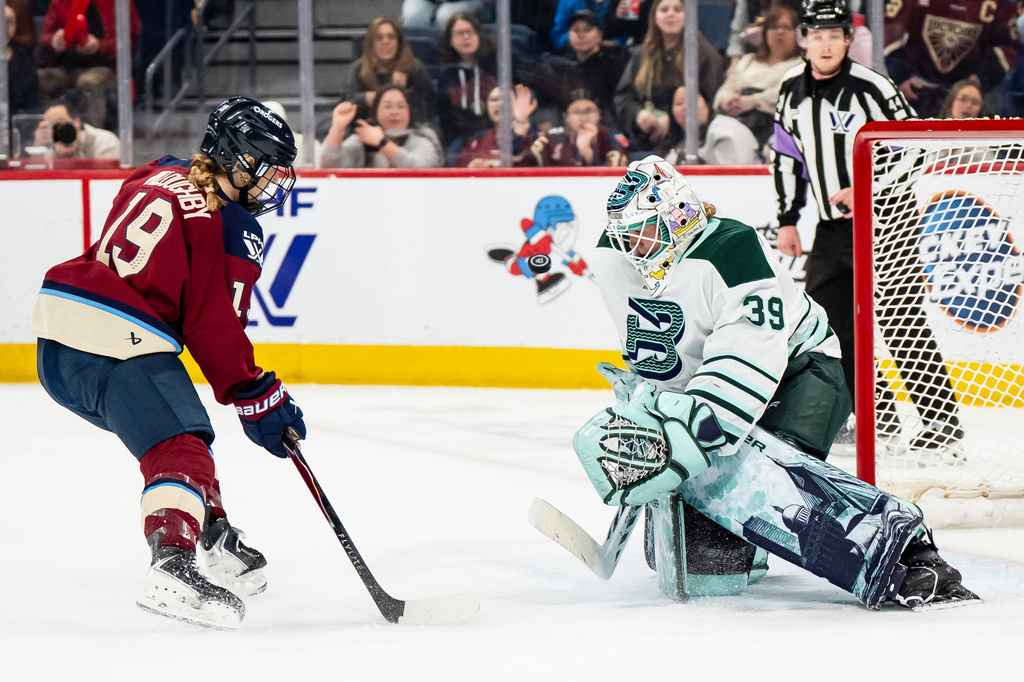 Boston Fleet goaltender Abbey Levy (39) makes a save against Montreal Victoire's Kaitlin Willoughby (19) during second-period PWHL hockey game action in Laval, Quebec, Friday, April 17, 2026. (Christopher Katsarov/The Canadian Press via AP)