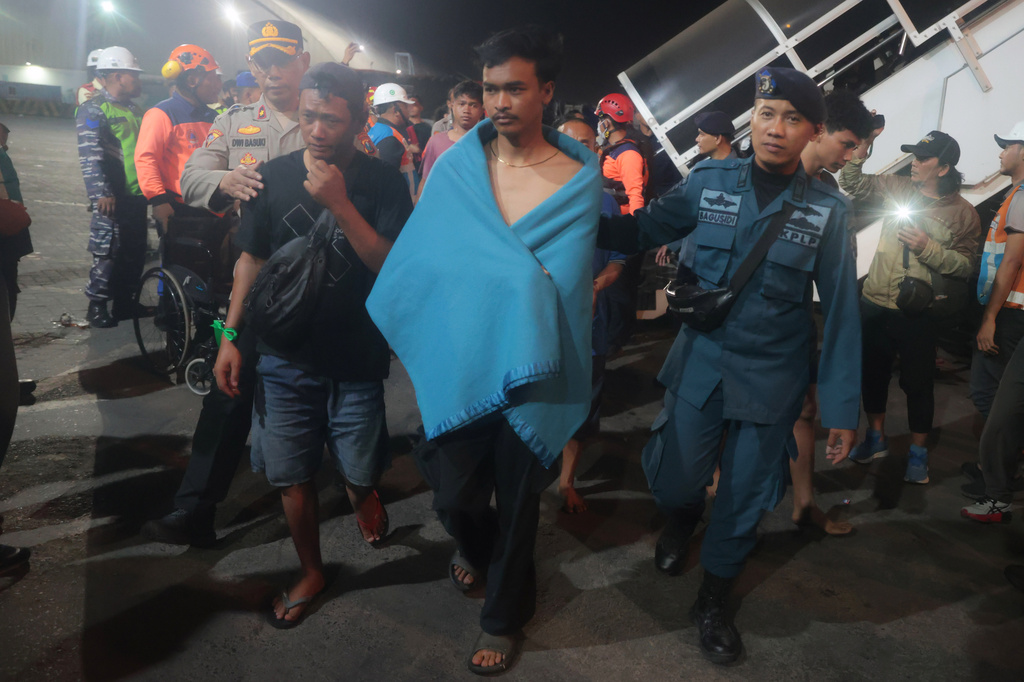 Survivors of a ferry fire arrive at Tanjung Perak Port in Surabaya, East Java, Indonesia, Monday, Aug. 3, 2026. (AP Photo/Trisnadi)