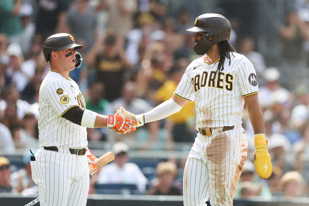 San Diego Padres' Fernando Tatis Jr., right, celebrates with teammate Jackson Merrill, left, after scoring on Manny Machado's RBI single in the third inning of a baseball game against the Washington Nationals, Monday, Sept. 7, 2026, in San Diego. (AP Photo/Karl Anderson)