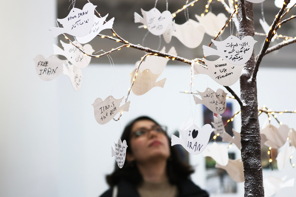 Hand written messages are posted on a tree, part of a dedicated memorial space for the lives lost in Iran, during the Pomexpo Norooz Bazaar in New York, on Saturday, March 14, 2026, for the upcoming Nowruz, Iranian/Persian New Year's day. (AP Photo/Heather Khalifa)
