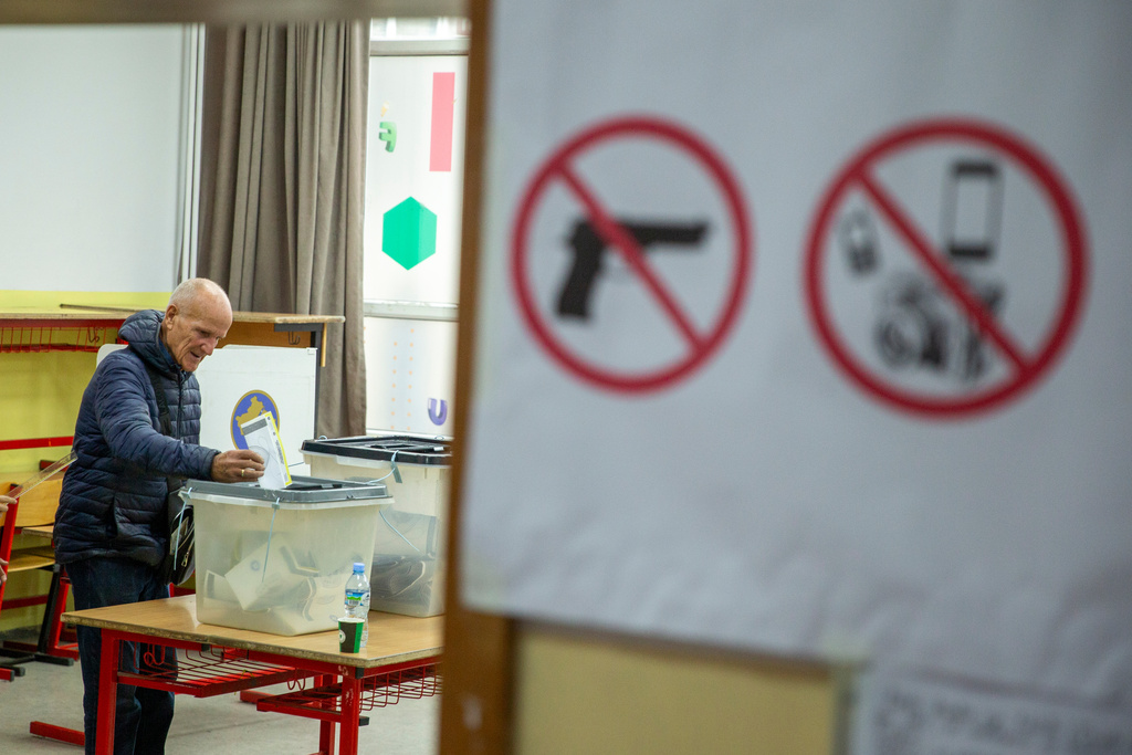 Voters cast their ballot for the municipal elections in Pristina, Kosovo on Sunday, Oct. 12, 2025. (AP Photo/Visar Kryeziu)