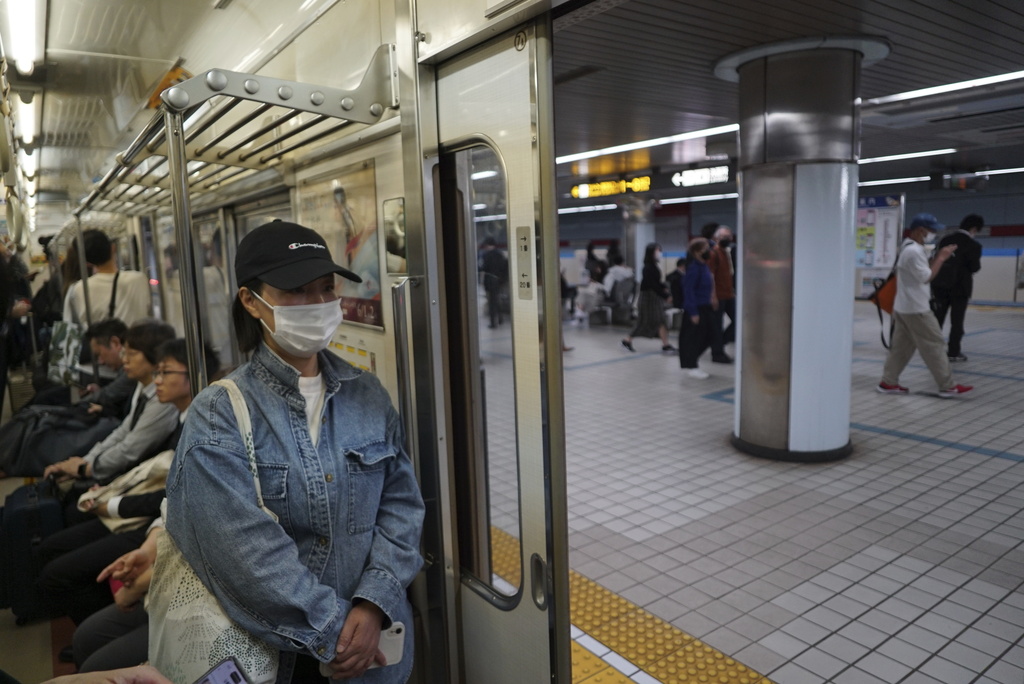 Yang Caiying, who is living in exile in Japan, rides the subway on her way to protest Chinese state repression of her family, at the Chinese consulate in Nagoya, Japan, Friday, May 17, 2024. (AP Photo/Dake Kang)