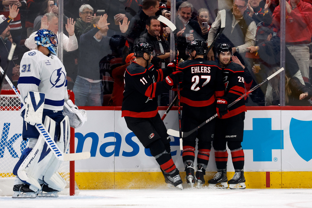 Carolina Hurricanes celibate a goal by Nikolaj Ehlers (27) with Tampa Bay Lightning goaltender Jonas Johansson (31) during the first period of an NHL hockey game in Raleigh, N.C., Thursday, Feb. 26, 2026. (AP Photo/Karl DeBlaker)