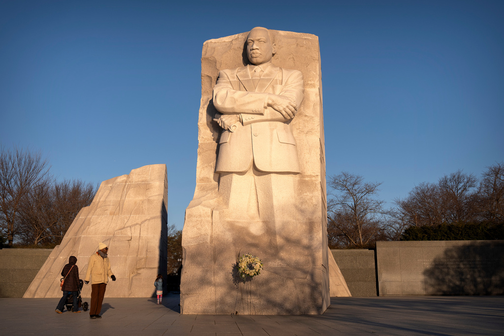 Visitors walk past the Martin Luther King Jr. Memorial Monday, Jan. 19, 2026, in Washington. (AP Photo/Mark Schiefelbein)