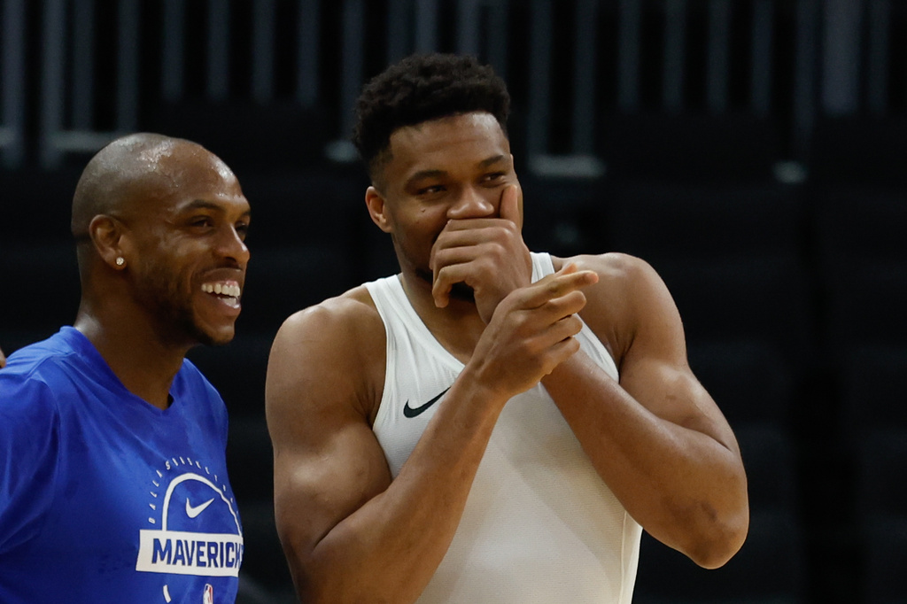 Milwaukee Bucks forward Giannis Antetokounmpo, right, talks to the Dallas Mavericks' Khris Middleton before an NBA basketball game Tuesday, March 31, 2026, in Milwaukee. (AP Photo/Jeffrey Phelps)