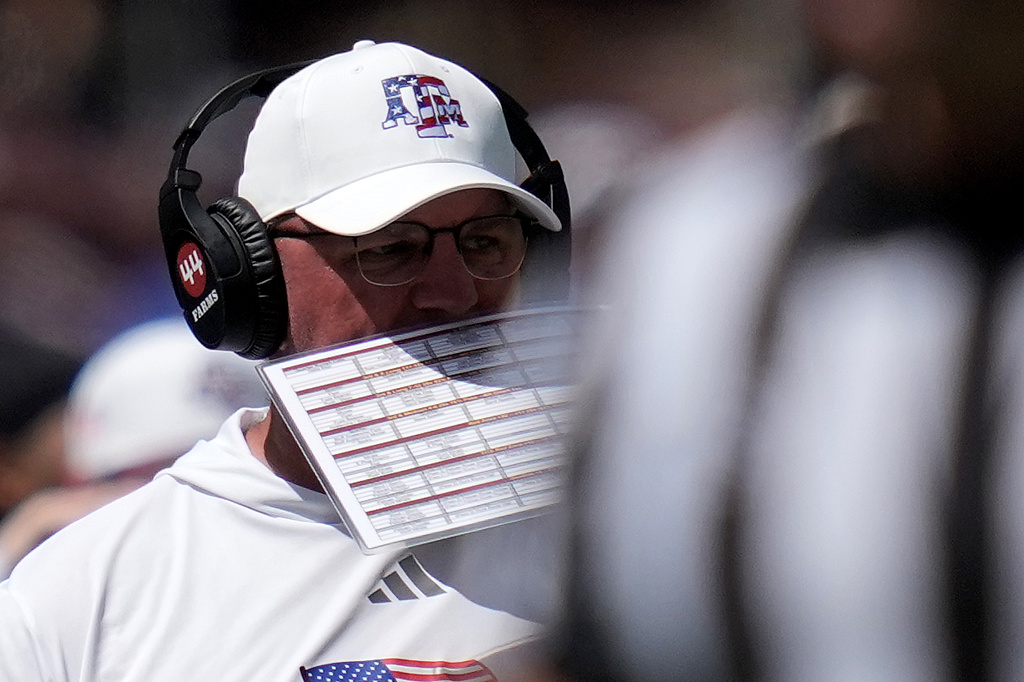 Texas A&M head coach Mike Elko calls in a play against Arizona State during the fourth quarter of an NCAA college football game Saturday, Sept. 12, 2026, in College Station, Texas. (AP Photo/Sam Craft)