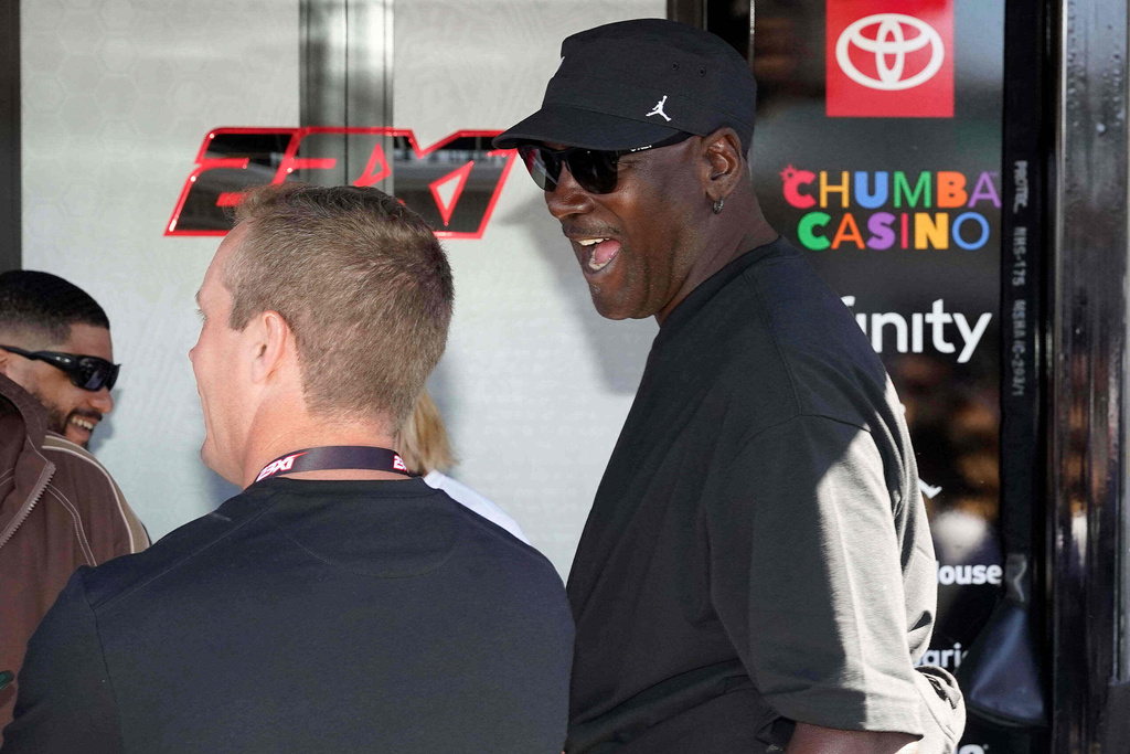 Michael Jordan part owner of 23XI Racing shares a laugh before a NASCAR Cup Series auto race at Phoenix Raceway, Sunday, March 8, 2026, in Avondale, Ariz. (AP Photo/Darryl Webb)