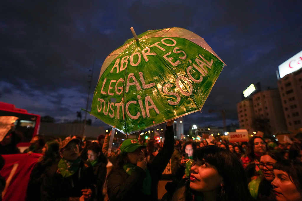 Demonstrators protest a proposed bill that would require women to listen to a fetal heartbeat before undergoing an abortion, in Santiago, Chile, Friday, July 31, 2026. (AP Photo/Esteban Felix)
