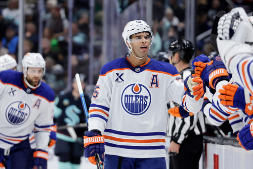 Edmonton Oilers defenseman Darnell Nurse (25) is greeted at the bench after scoring against the Seattle Kraken in the third period of an NHL hockey game Saturday, Oct. 25, 2025, in Seattle. (AP Photo/John Froschauer) Edmonton Oilers defenseman Darnell Nurse (25) is greeted at the bench after scoring against the Seattle Kraken in the third period of an NHL hockey game Saturday, Oct. 25, 2025, in Seattle. (AP Photo/John Froschauer)