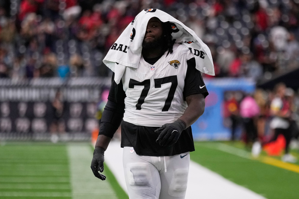 Jacksonville Jaguars offensive tackle Anton Harrison (77) walks off the field after a lose to the Houston Texans after an NFL football game, Sunday, Nov. 9, 2025, in Houston. (AP Photo/Eric Christian Smith)