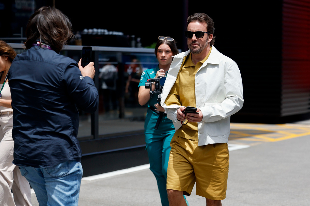Aston Martin driver Fernando Alonso of Spain, right, walks at the Barcelona Catalunya racetrack in Montmelo, near Barcelona, Spain, Thursday, June 11, 2026. (AP Photo/ Joan Monfort)