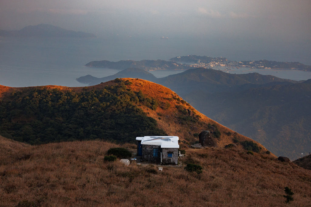 A long-tailed shrike mural is seen painted on the rooftop of a stone house on Sunset Peak, Lantau, Hong Kong, Jan. 25, 2025. (AP Photo/May James)