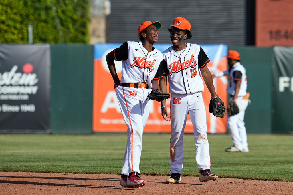 McClymonds High School Tyler Higginbotham, left, and Antuan Mason (10) share a laugh during the fourth inning of a baseball game against Skyline High School in Oakland, Calif., Friday, May 1, 2026. (AP Photo/Godofredo A. Vásquez)