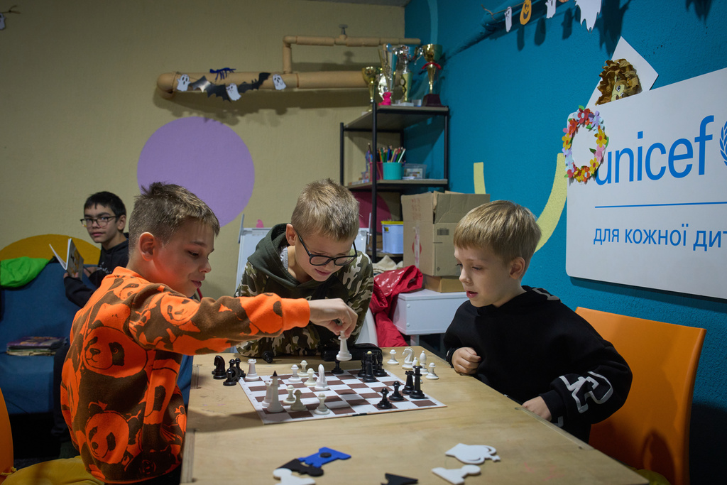 Children play chess in an underground shelter in the frontline city of Kherson, Southern Ukraine, Nov. 2, 2025. (AP Photo/Efrem Lukatsky)