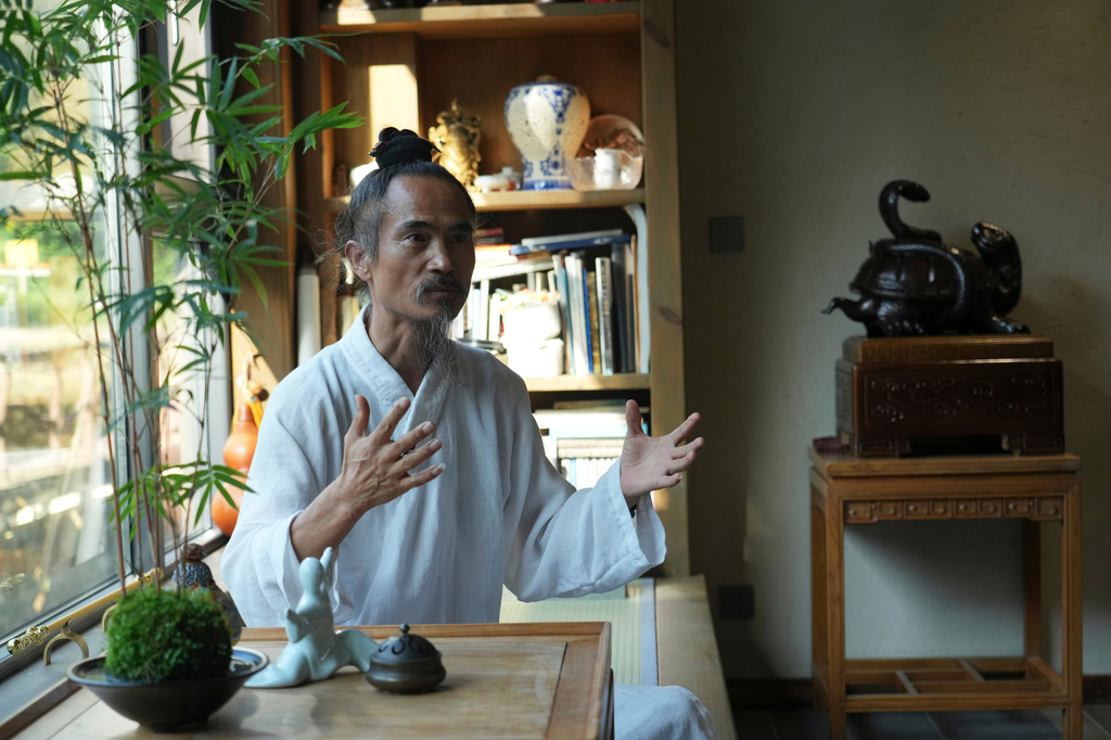 Yuan Shimao, founder of Wudang Taoist Traditional Kung Fu academy, gestures as he speaks on the grounds of the academy near Wudang Mountain in Shiyan city in central China's Hubei province on Friday, Sept. 4, 2026. (AP Photo/Achmad Ibrahim)