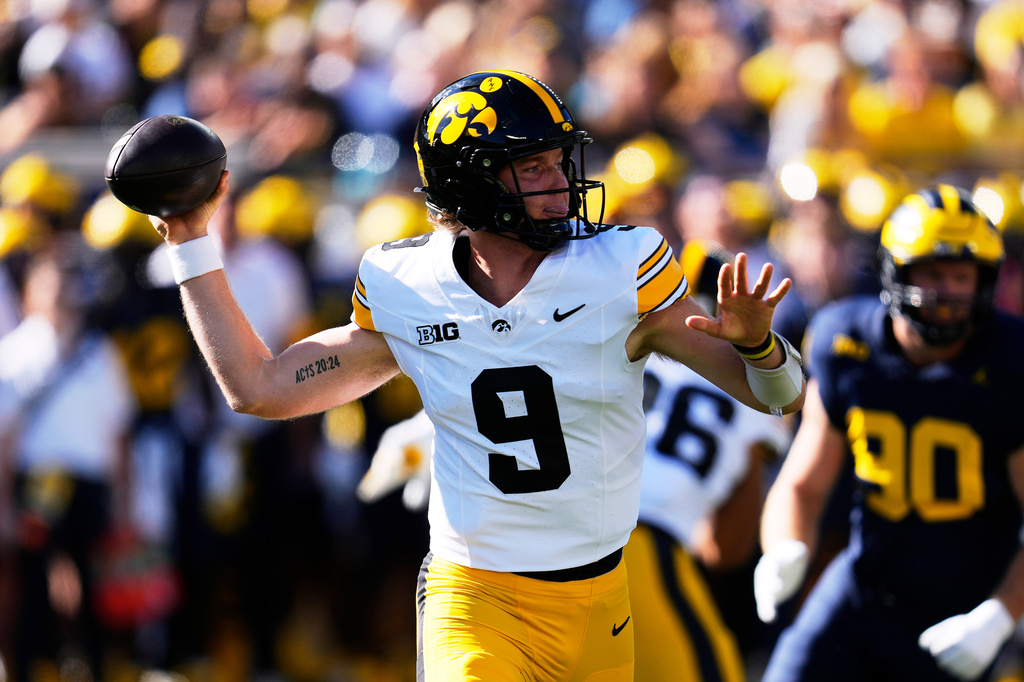 Iowa quarterback Hank Brown (9) throws against Michigan during the first half of an NCAA college football game in Ann Arbor, Mich., Saturday, Sept. 26, 2026. (AP Photo/Paul Sancya)