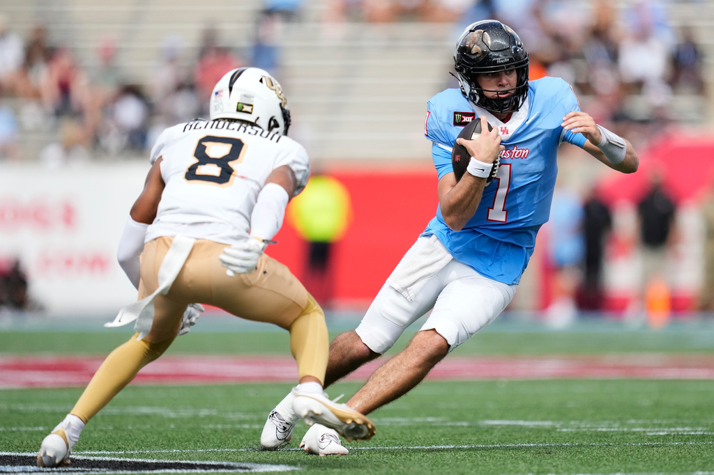 Houston quarterback Conner Weigman (1) runs the ball against UCF defensive back Demari Henderson (8) during the first half of an NCAA college football game in Houston, Saturday, Oct. 3, 2026. (AP Photo/Ashley Landis)