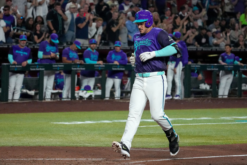 Arizona Diamondbacks' Nolan Arenado approaches home plate after hitting a home run during the fourth inning of an baseball game against the Toronto Blue Jays Friday, April 17, 2026, in Phoenix. (AP Photo/Darryl Webb)