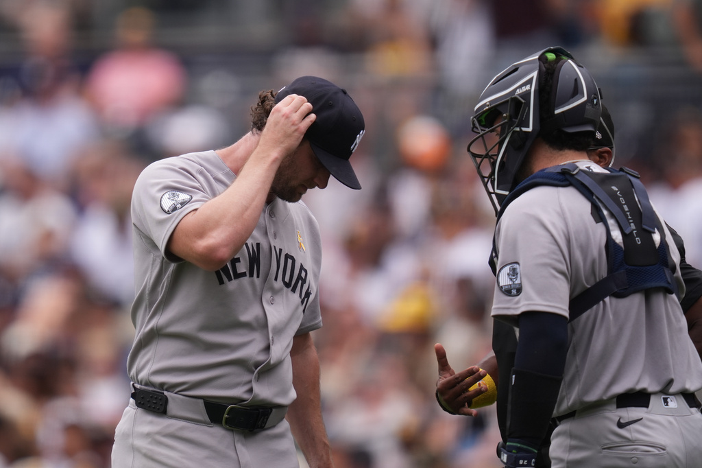 New York Yankees starting pitcher Gerrit Cole, left, talks with Austin Wells after giving up three home runs during the first inning of a baseball game against the San Diego Padres Sunday, Sept. 6, 2026, in San Diego. (AP Photo/Gregory Bull)