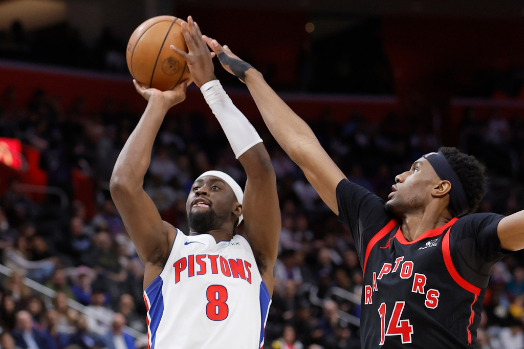 Detroit Pistons guard Caris LeVert (8) takes a shot while being defended by Toronto Raptors guard Ja'kobe Walter (14) during the second half of an NBA basketball game Tuesday, March 31, 2026, in Detroit. (AP Photo/Duane Burleson)