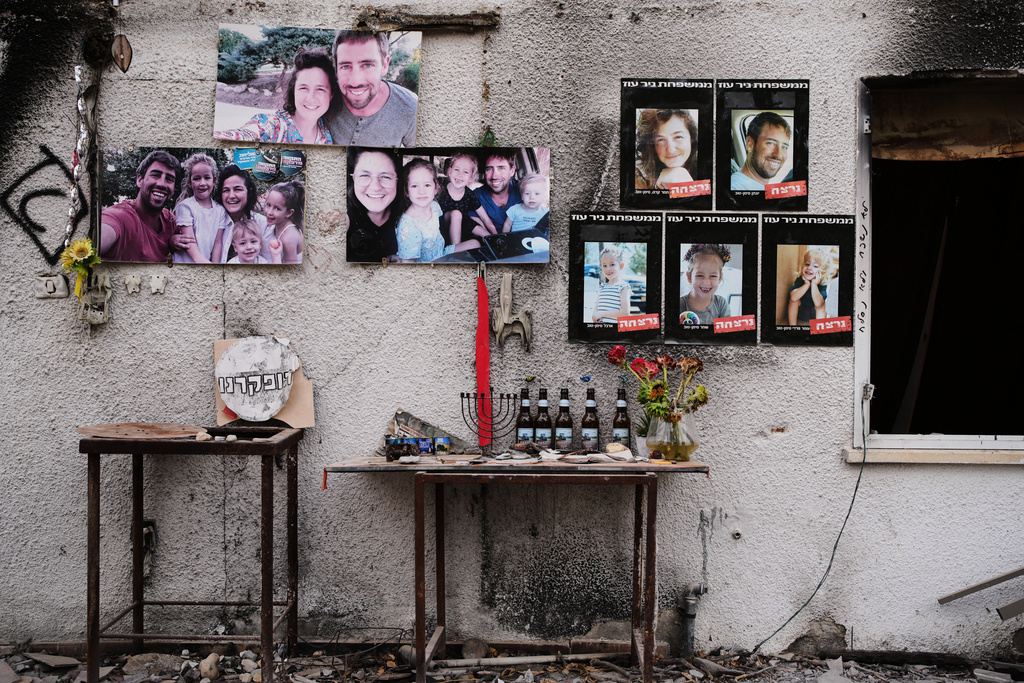 Photos of the Siman Tov family are plastered on their burnt house where all five of them were killed during the Hamas attack on Oct. 7, 2023, in Kibbutz Nir Oz, Israel, a day before Israel marks the two-year anniversary of the attack, Monday, Oct. 6, 2025. (AP Photo/Ohad Zwigenberg)