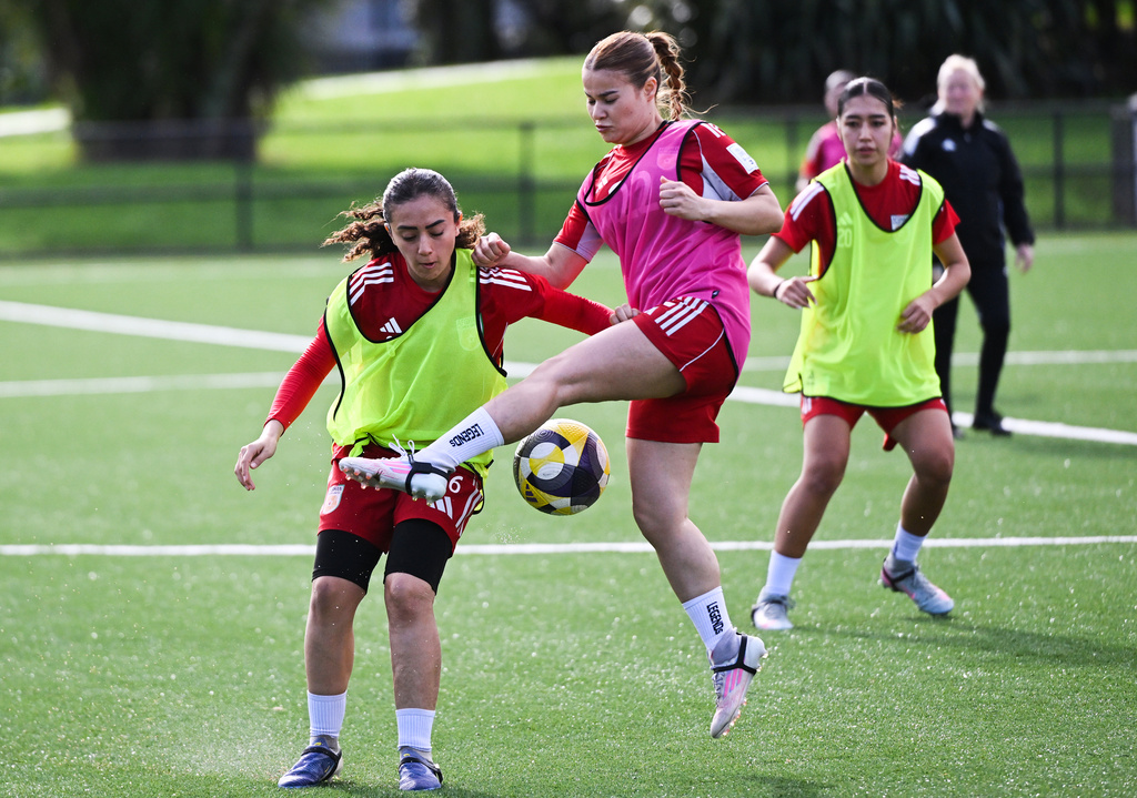 Afghan soccer players Mona Amini, left, and Sosan Mohammadi compete for the ball during a training session in Auckland, New Zealand, Tuesday, June 2, 2026. (Andrew Cornaga/Photosport via AP)