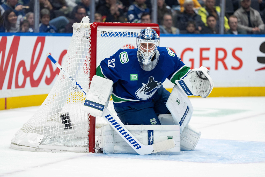 Vancouver Canucks' goaltender Kevin Lankinen (32) watches during the second period of an NHL hockey game against the Utah Mammoth in Vancouver, on Friday, Dec. 5, 2025. (Ethan Cairns/The Canadian Press via AP)