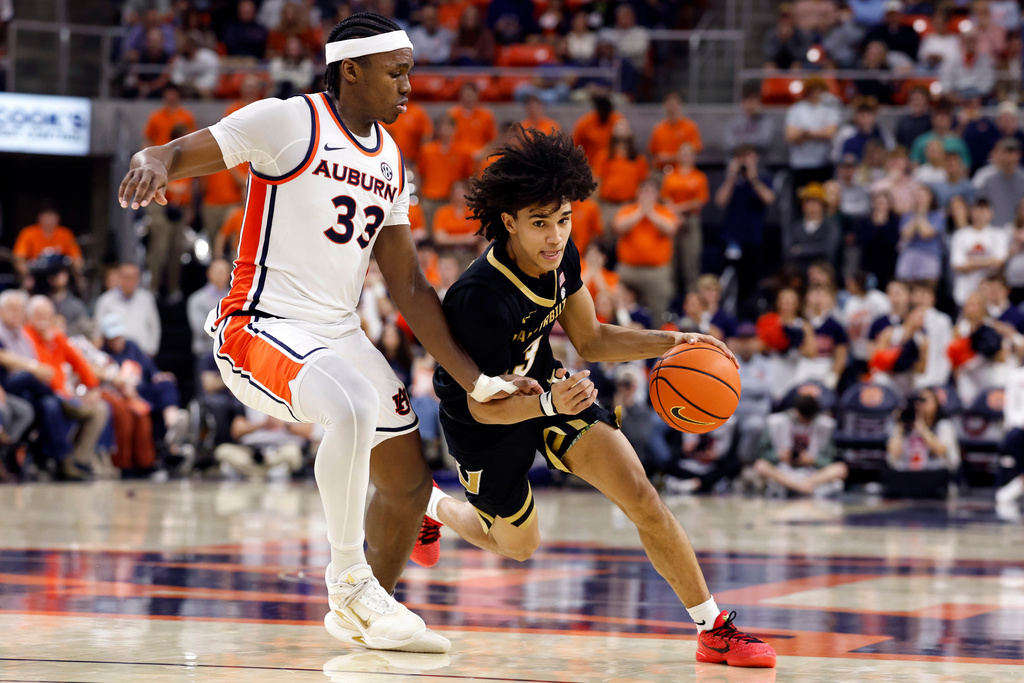 Vanderbilt guard Tyler Tanner (3) dribbles around Auburn forward Sebastian Williams-Adams (33) during the first half of an NCAA college basketball game Tuesday, Feb. 10, 2026, in Auburn, Ala. (AP Photo/Butch Dill)